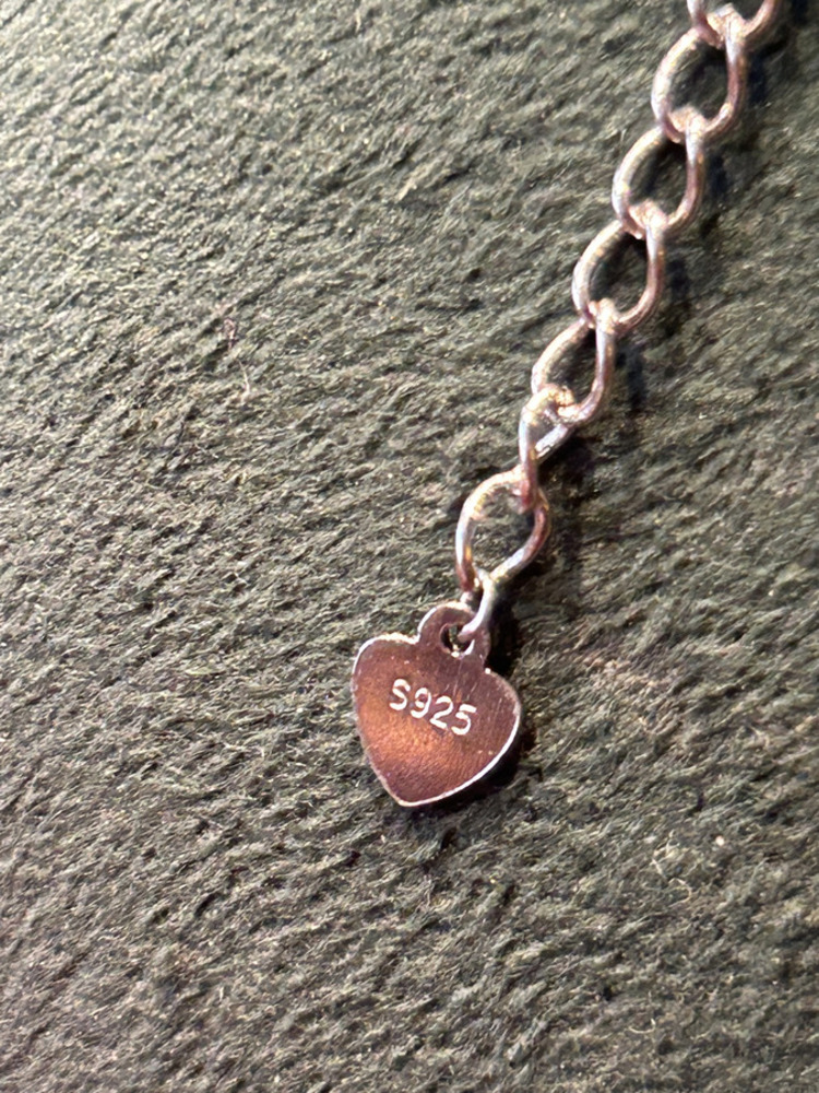 Emerald Sunburst Necklace — hallmark close-up