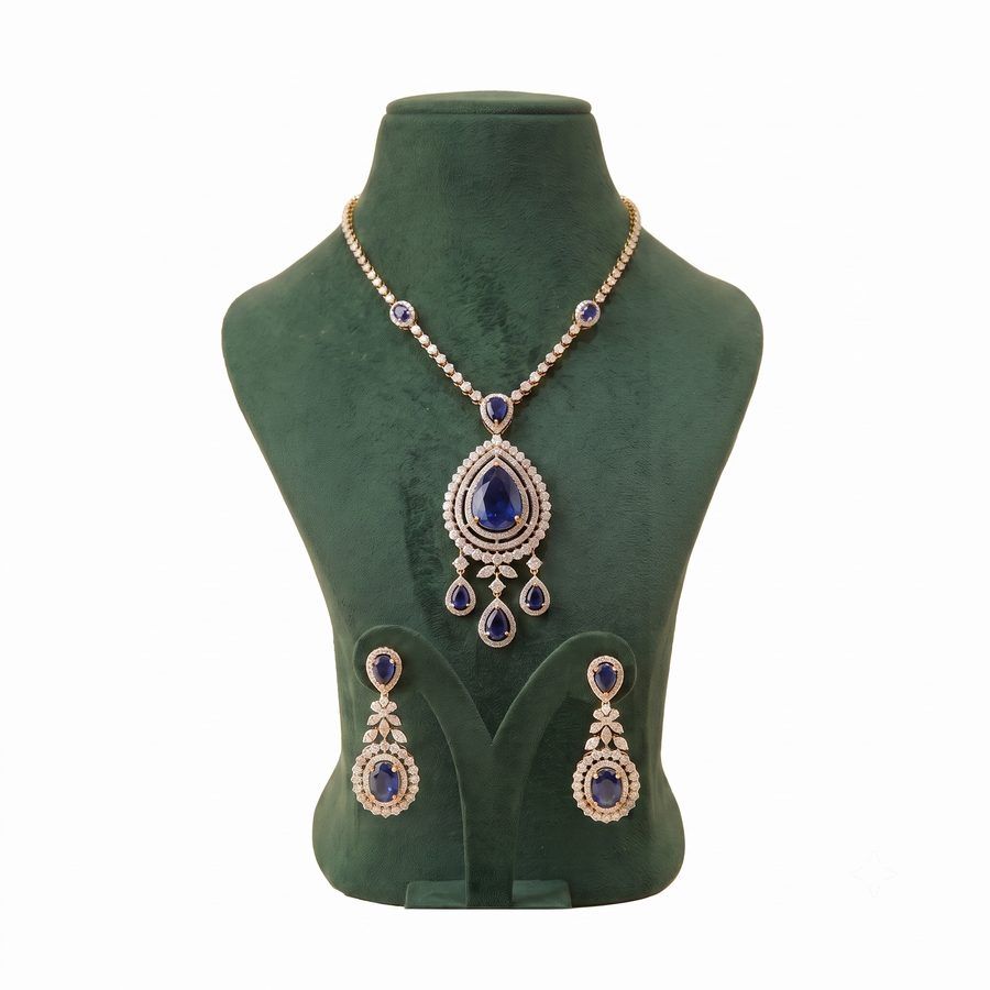 Rose gold pendant necklace set with sapphire blue stones and matching drop earrings